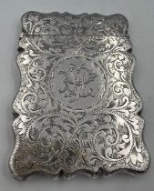 A silver card case with foliage scroll engraving and initials to front. 9cm x 6.5cm. Birmingham