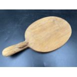 Robert Thompson 'Mouseman' of Kilburn, an adzed oak cheese board of oval form with a carved mouse