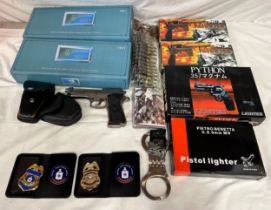 Various lighters in the form of guns, boxed together with handcuffs and keys, one pair Star, CIA &