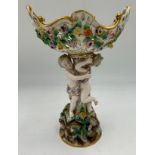 A Meissen table centrepiece with a pierced twin-handled basket, a supporting column with two putti