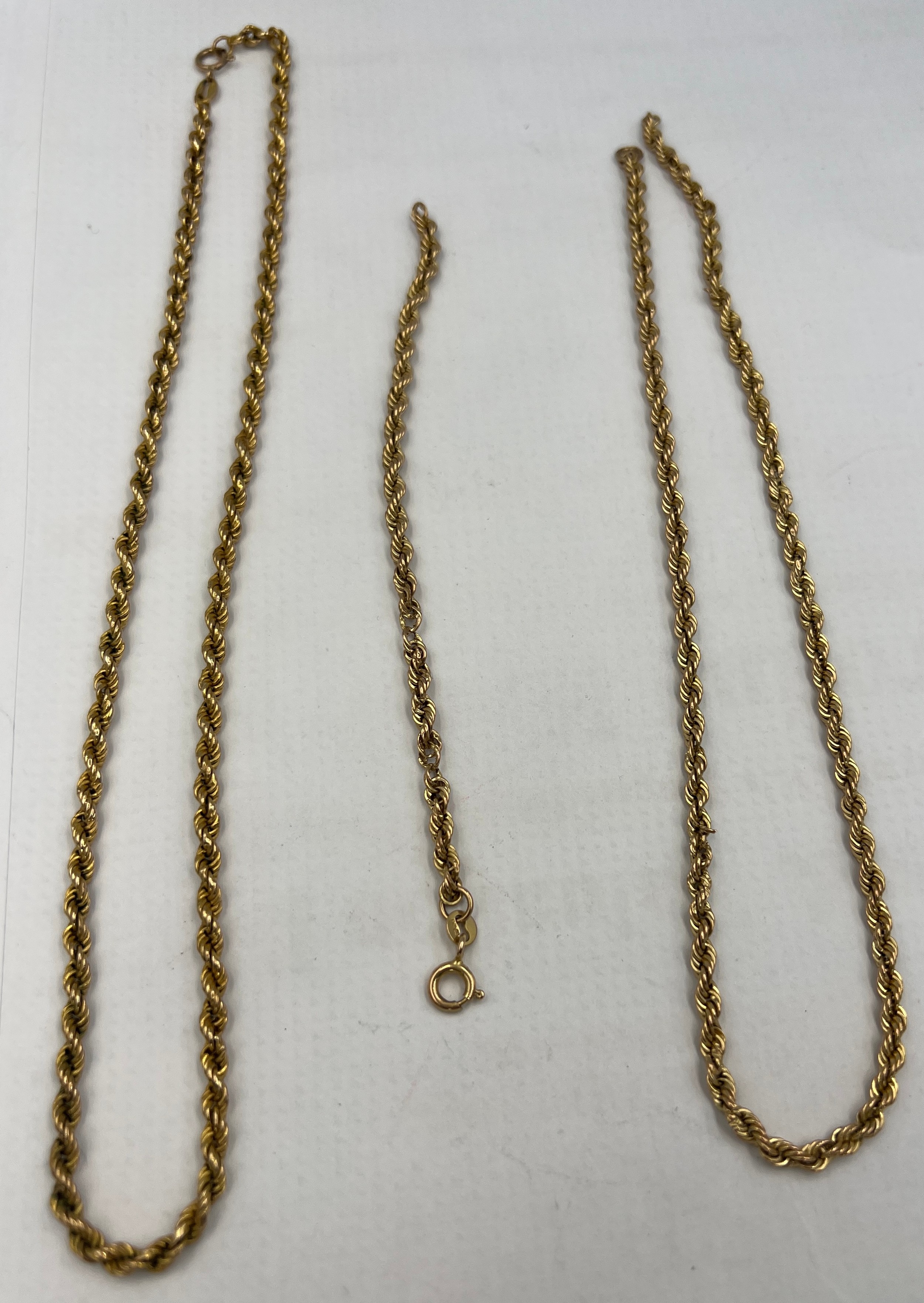Two 9 carat gold twist chain necklaces and a 9 carat gold bracelet.Total weight 8.4gm.