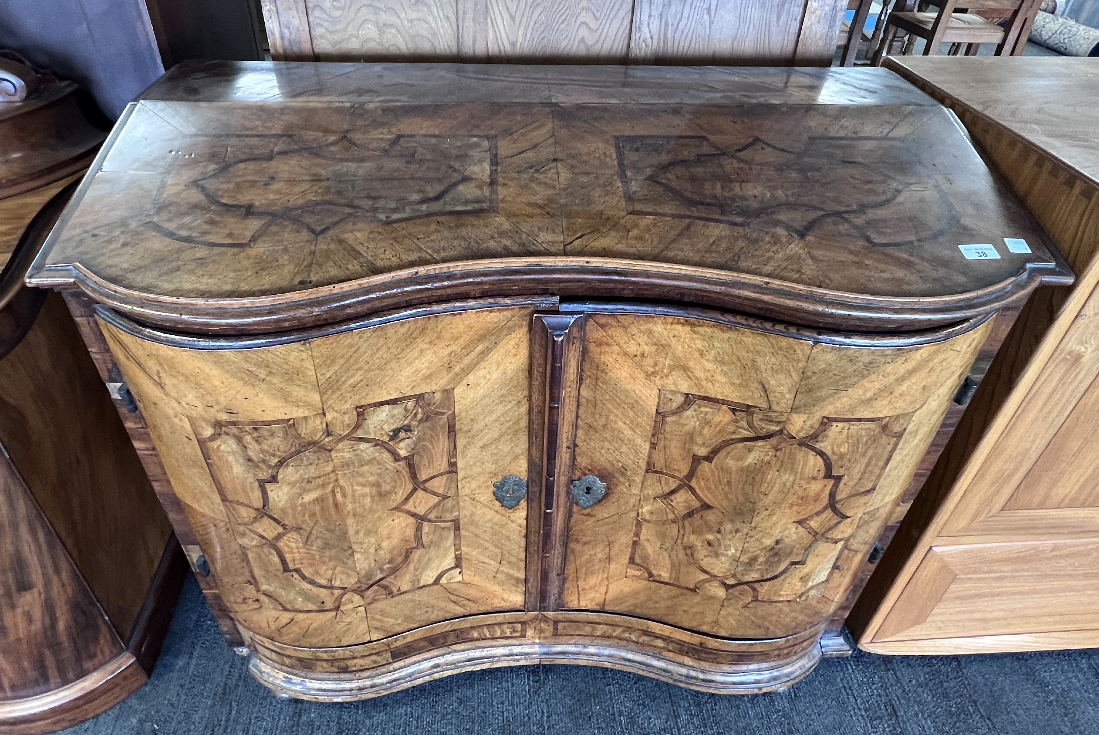 An 18thC Austrian two door inlaid cabinet with sloping top and drawer to base. 109cm w x 94cm h x