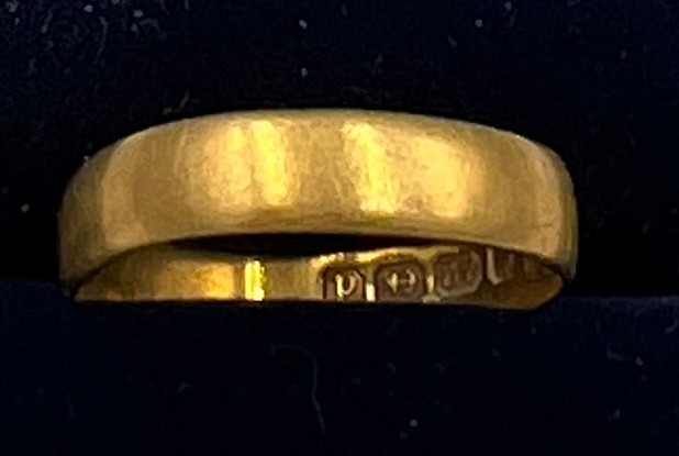 A 22 carat gold wedding band. Size M. Weight 2.5gm.