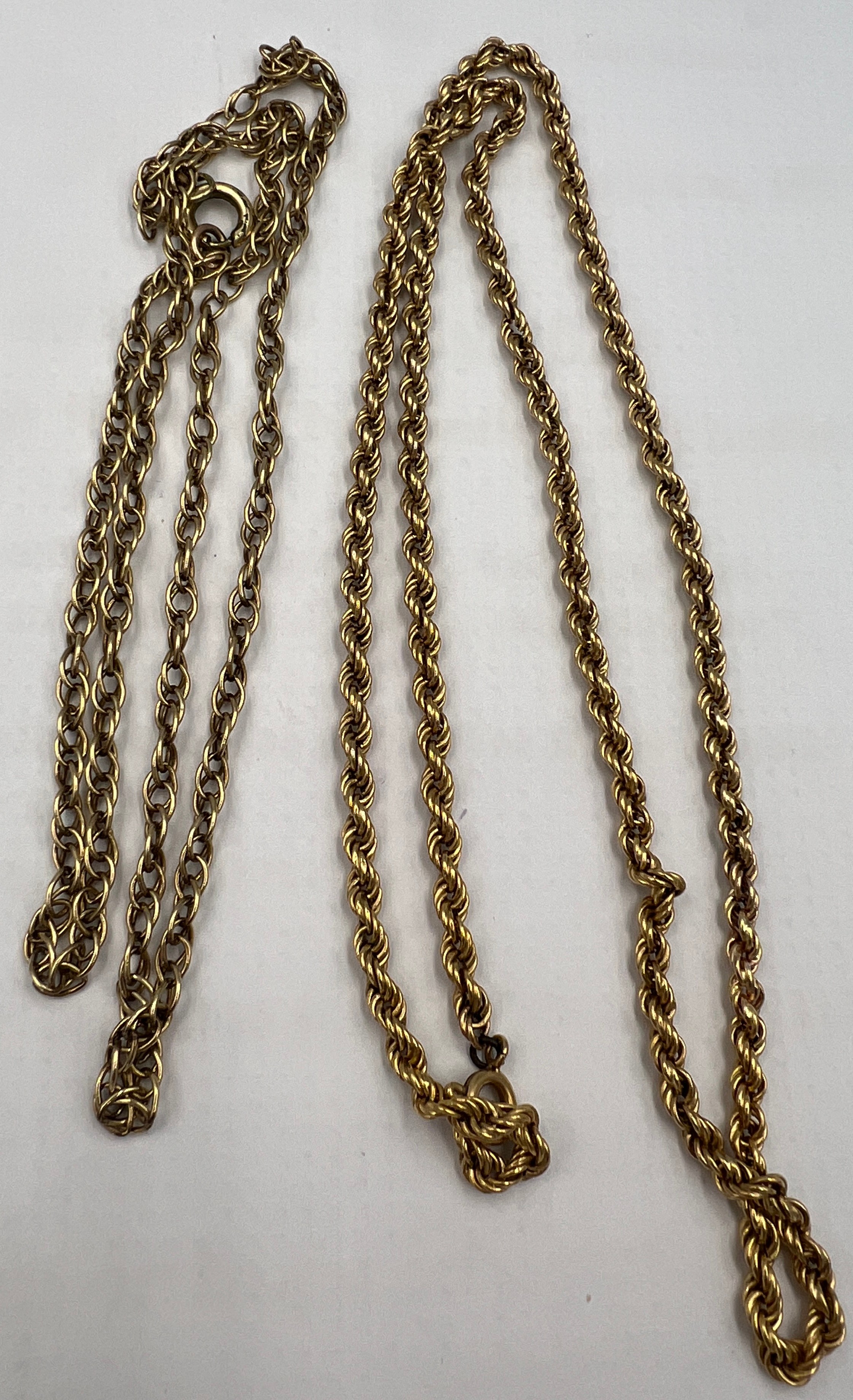 Two yellow metal chain necklaces, one marked 9carat 6.1gm the other marked 18 carat, weight 7.5gm.