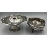 Two Indian white metal bowls, one on a pedestal and embossed with elephants and other animals, the