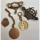 A quantity of mainly 19thC tags, badges and brooches to include 18 and 9 carat gold, unmarked yellow