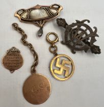 A quantity of mainly 19thC tags, badges and brooches to include 18 and 9 carat gold, unmarked yellow