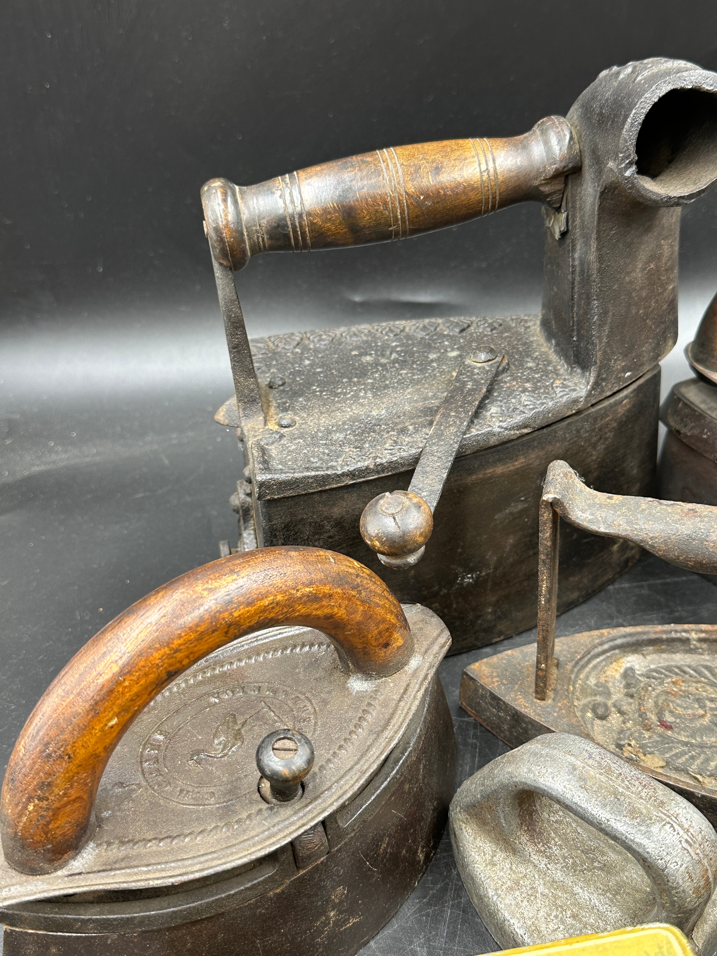 A collection of sad irons, CH Crane, Otto etc together with various tins to include Rowntree's - Image 6 of 10