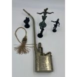 Four metal figures and a Chinese metal opium pipe.