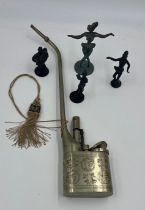 Four metal figures and a Chinese metal opium pipe.
