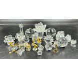 A collection of Swarovski Crystal to include waterlily candleholder, 4 x paperweight largest 6cm
