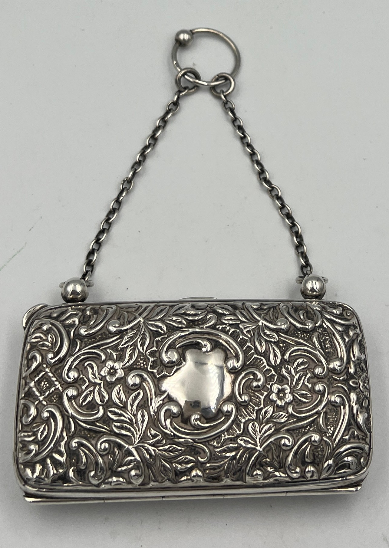 A hallmarked silver purse with chain and finger ring with repoussé decoration and vacant - Image 2 of 3