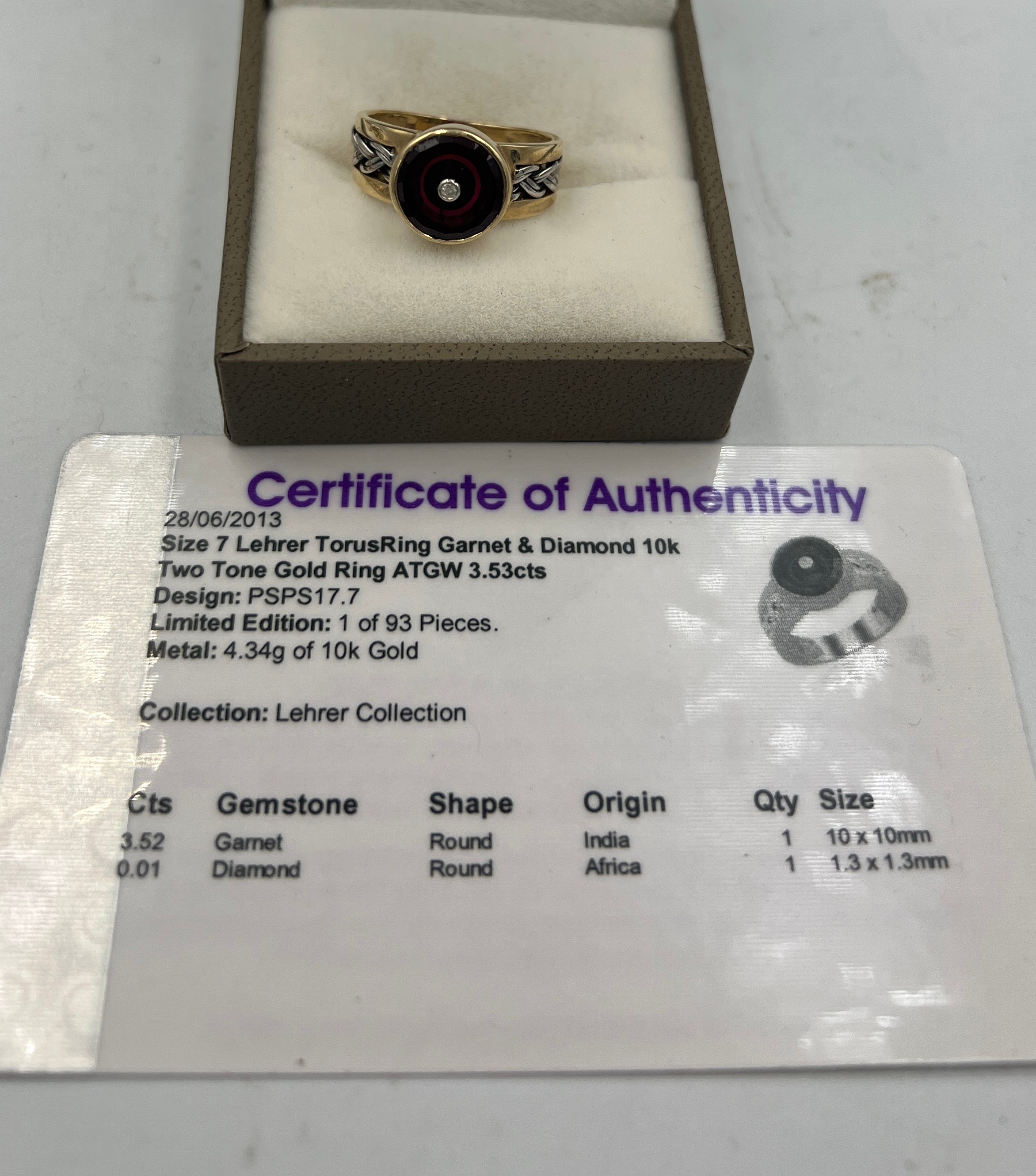 A 9 carat gold ring set with garnet and diamond. Size N. Weight 4.5gm. With certificate of - Bild 2 aus 3