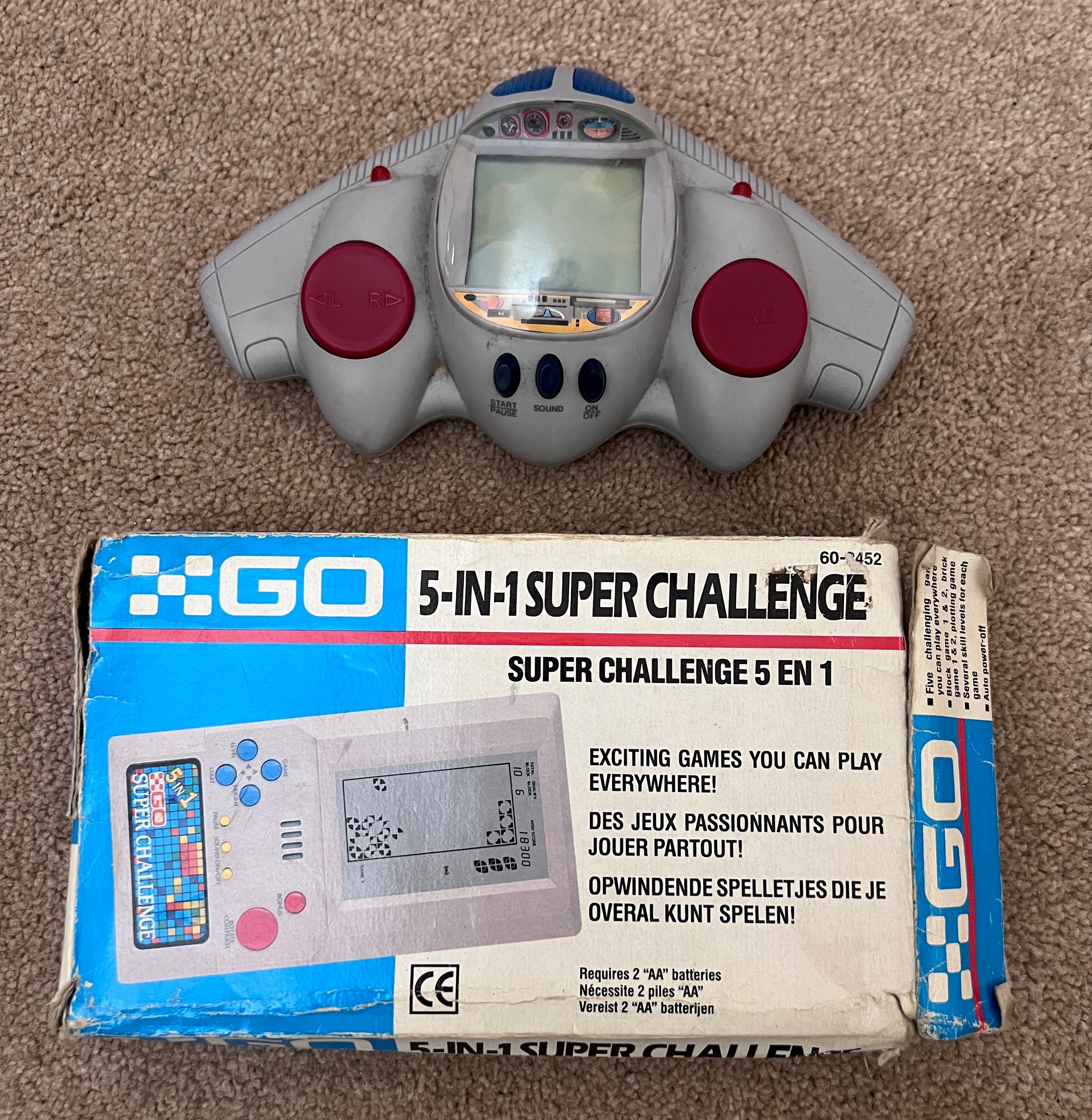 A Go 5-in-1 super challenge handheld game console together with a Radioshack handheld shooting game.