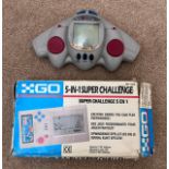 A Go 5-in-1 super challenge handheld game console together with a Radioshack handheld shooting game.