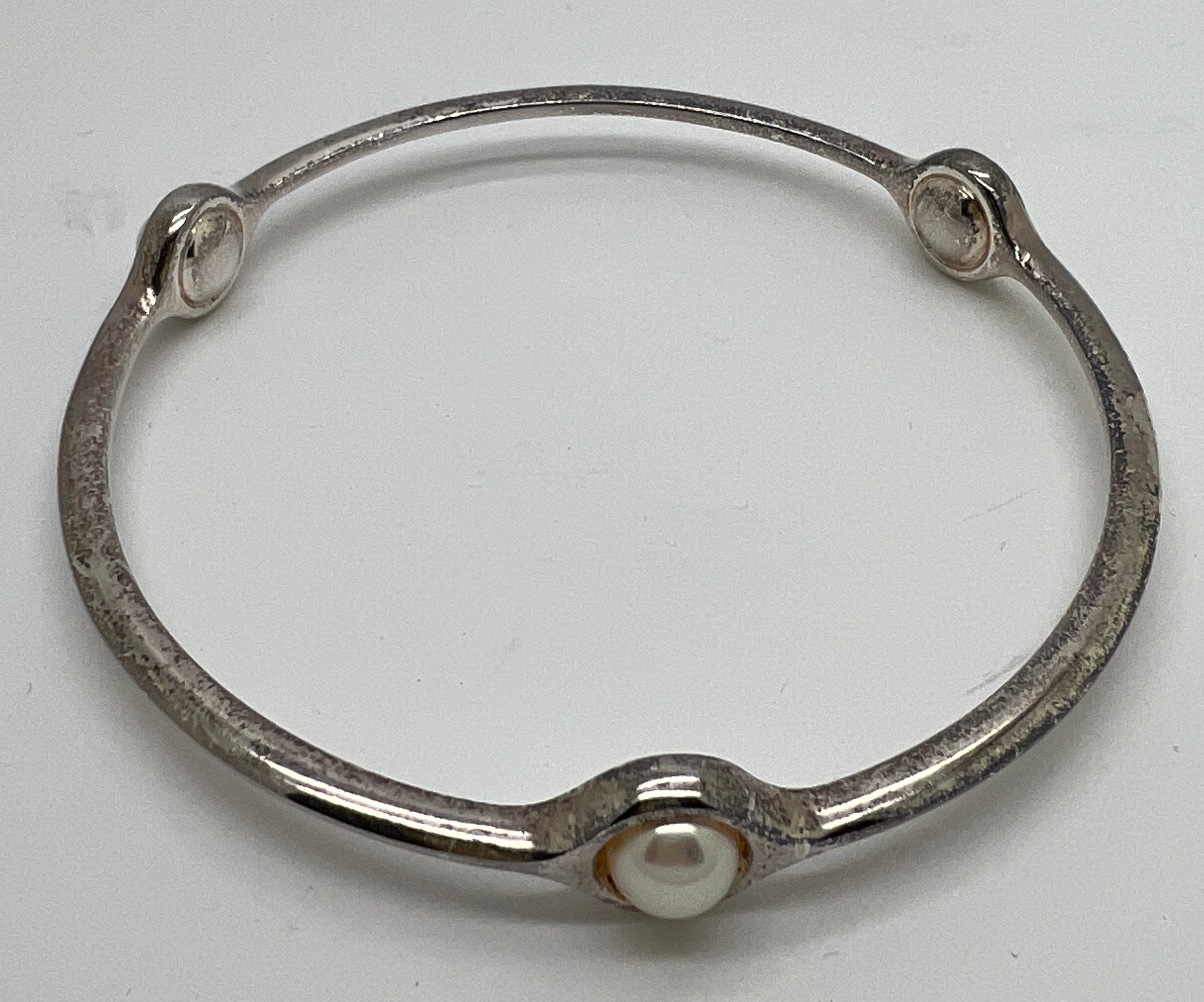 A Georg Jensen 473 sterling silver and pearl bangle. Interior measurement 6.5cm approximately.