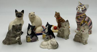 A collection of ceramic cats to include a Royal Crown Derby seated cat with gold stopper (13cm)