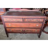 An American chest of two short over two long drawers with painted floral decoration to front.