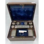 A Victorian rosewood and mother of pearl travelling box with its original fittings, secret drawer to