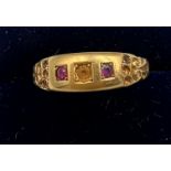 A 18 carat gold ring set with two pink stones. Size Q. Weight 2.7gm.