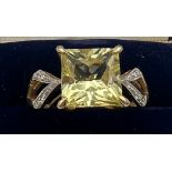 A 9 carat gold ring set with yellow and clear stones. Size P. Weight 3gm.