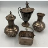 Silver and unmarked white metal to include two pepper pots, napkin ring, cup and unmarked lid and