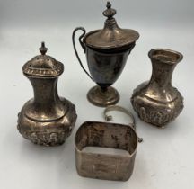 Silver and unmarked white metal to include two pepper pots, napkin ring, cup and unmarked lid and