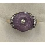A 10 carat gold ring set with amethyst and diamond. Size N. Weight 3.2gm. With certificate of