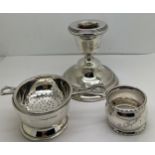 Silver to include tea strainer on bowl, napkin ring and a candlestick with weighted base. Various