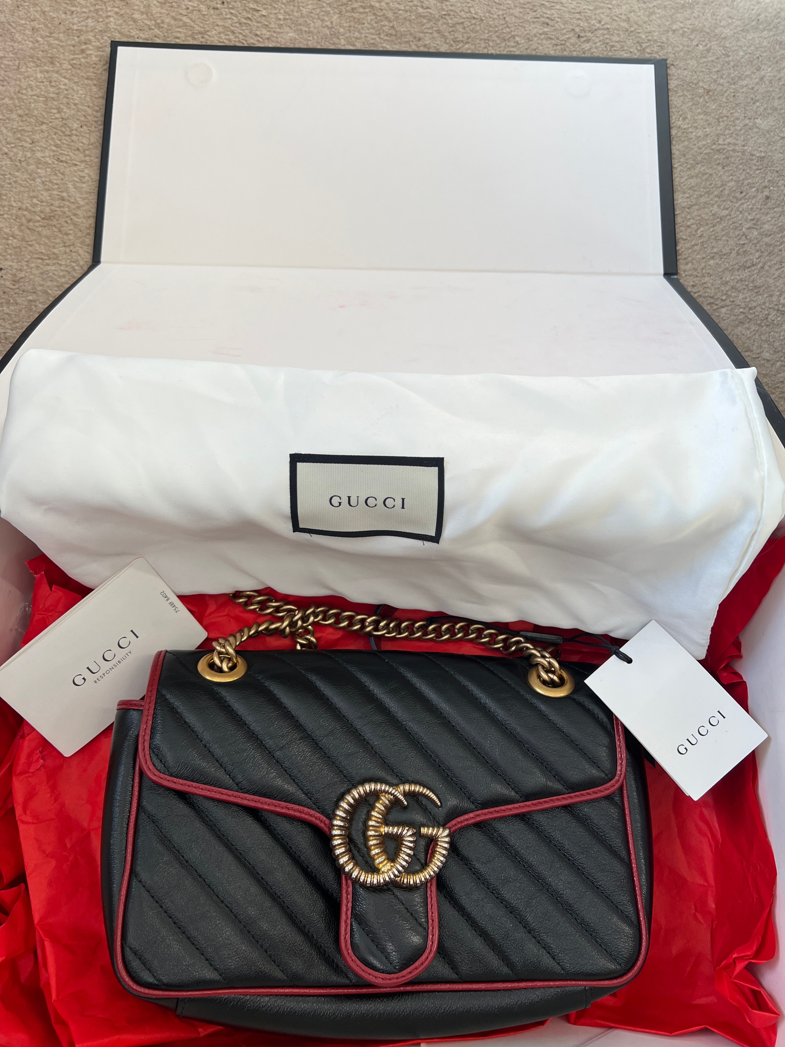 A Gucci Marmont black with red trim and gold coloured chain hand bag, together with original box and - Image 3 of 9