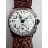 A 1910'a gentleman's silver cased wristwatch on brown leather strap and subsidiary seconds dial with