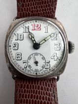 A 1910'a gentleman's silver cased wristwatch on brown leather strap and subsidiary seconds dial with