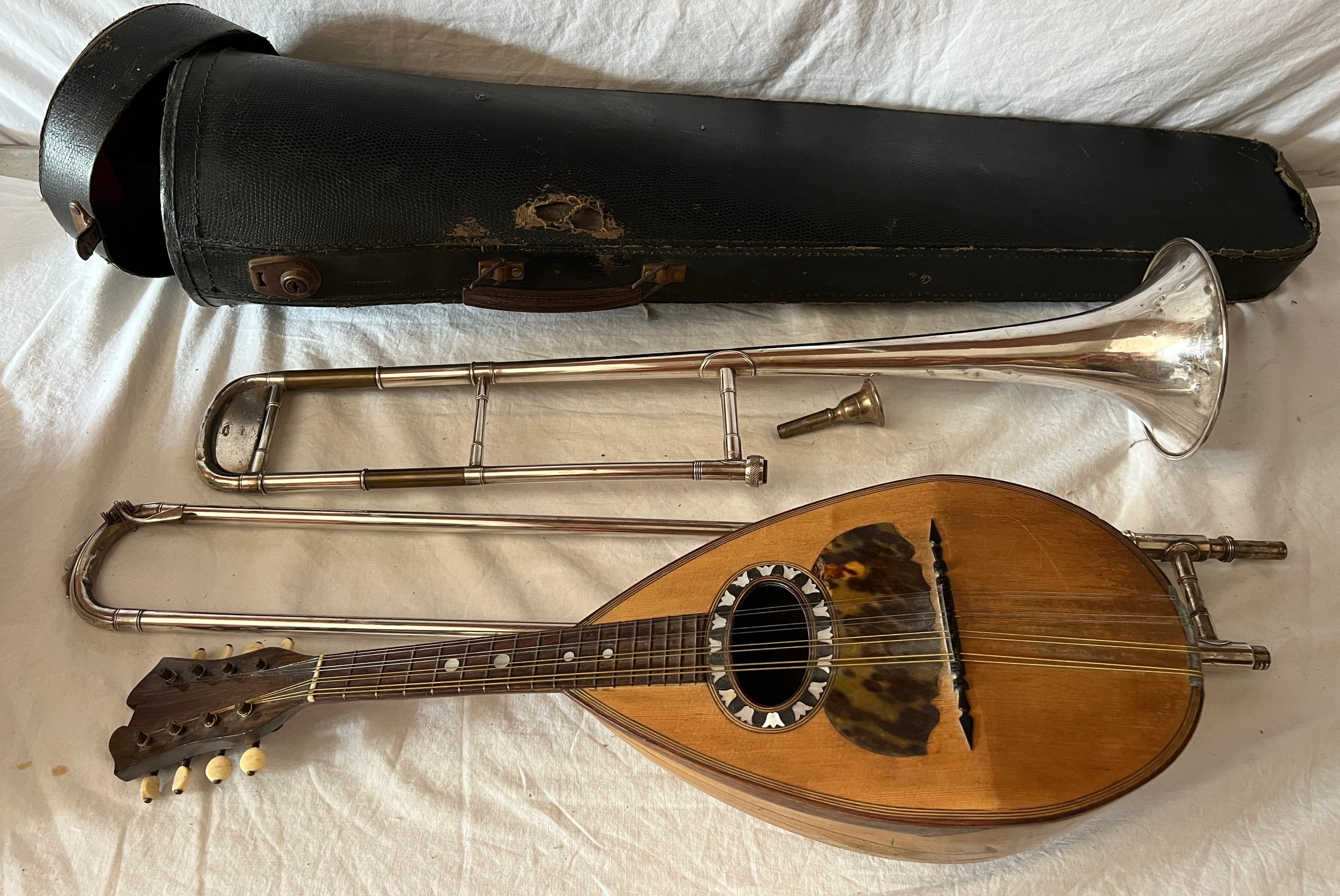 An early 20thC mandolin together with a vintage cased Besson & Co. trombone.