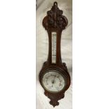 A carved oak barometer. Mercury barometer detaches. 92cm h.