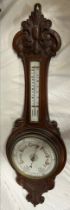 A carved oak barometer. Mercury barometer detaches. 92cm h.