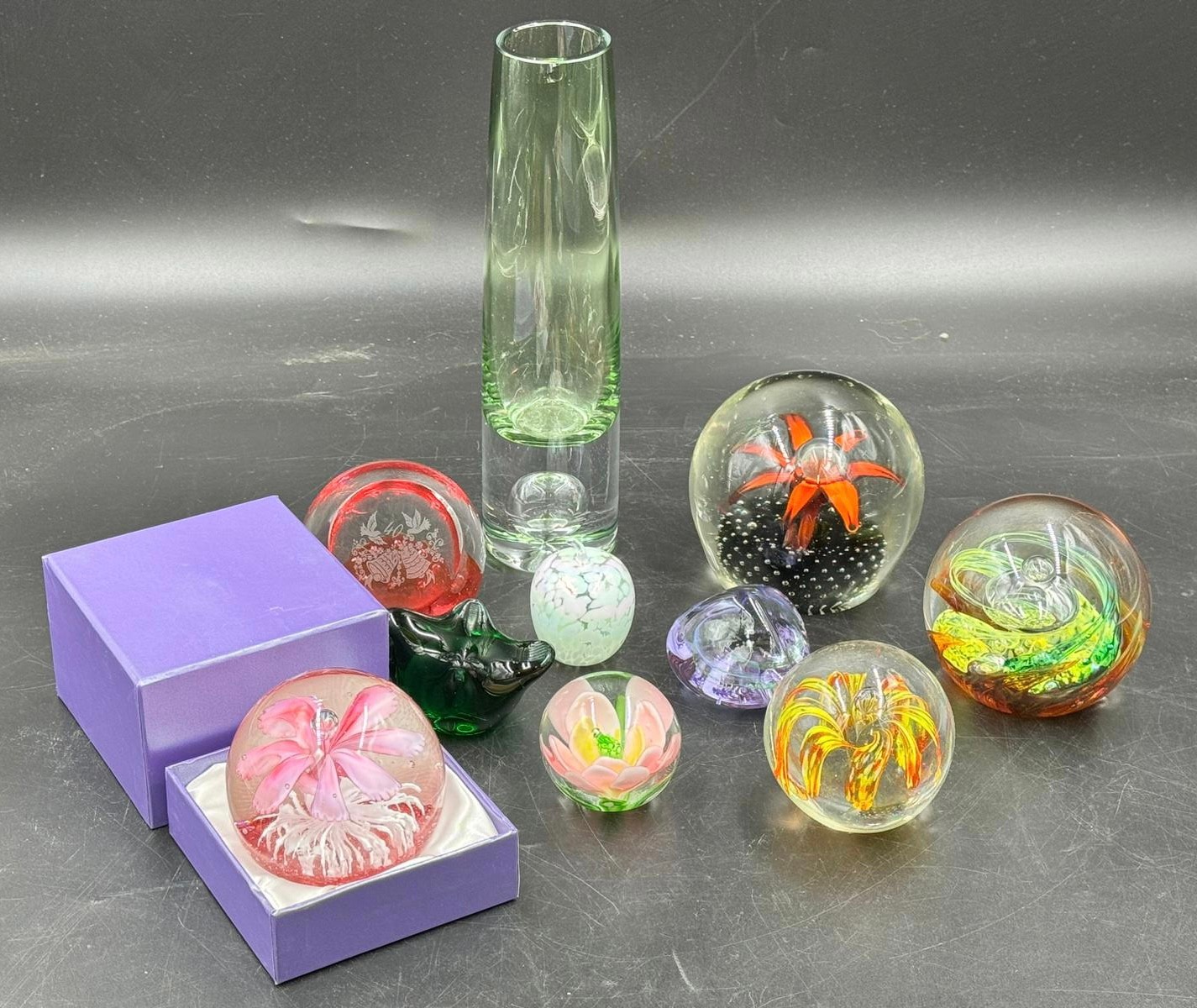 A collection of glass paperweights to include one Selkirk, 2x Caithness, together with a glass vase.