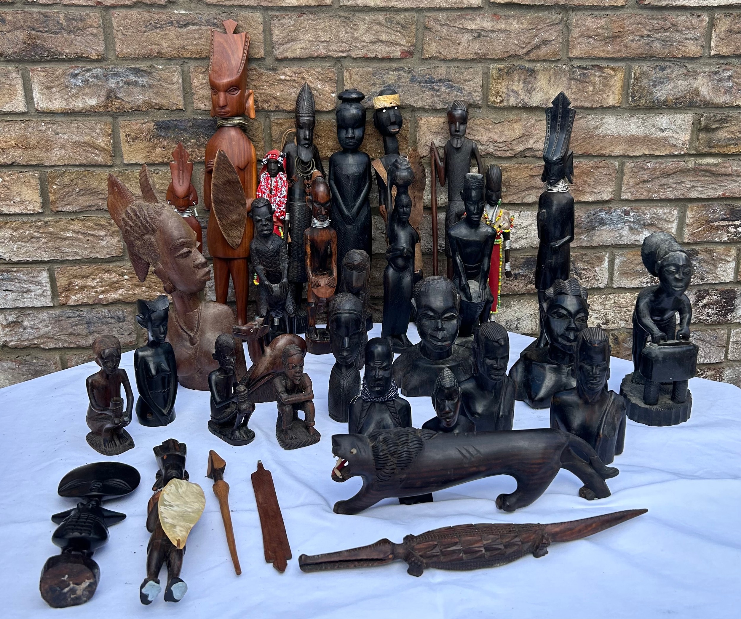 A quantity of wooden statues, busts, ornaments, majority in dark wood. Tallest 47cm h, lion 29cm