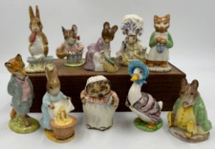 Ten Beswick Beatrix Potter figures comprising: Lady Mouse, Hunca Munca Sweeping, Samuel Whiskers,