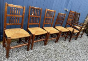 Six elm chairs, two carvers and four single, with rush seats. One carver approx. 110cm h x 59cm w (