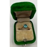 A 9 carat gold ring set with single blue stone. Size J. Weight 1.5gm. In Green velvet and silk lined