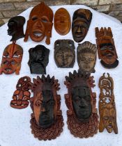 Tribal wall hanging masks to include a pair 30 x 17cm. (13)