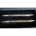 An Aston Martin pen and pencil set in original presentation box and outer cardboard case.