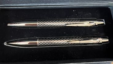 An Aston Martin pen and pencil set in original presentation box and outer cardboard case.