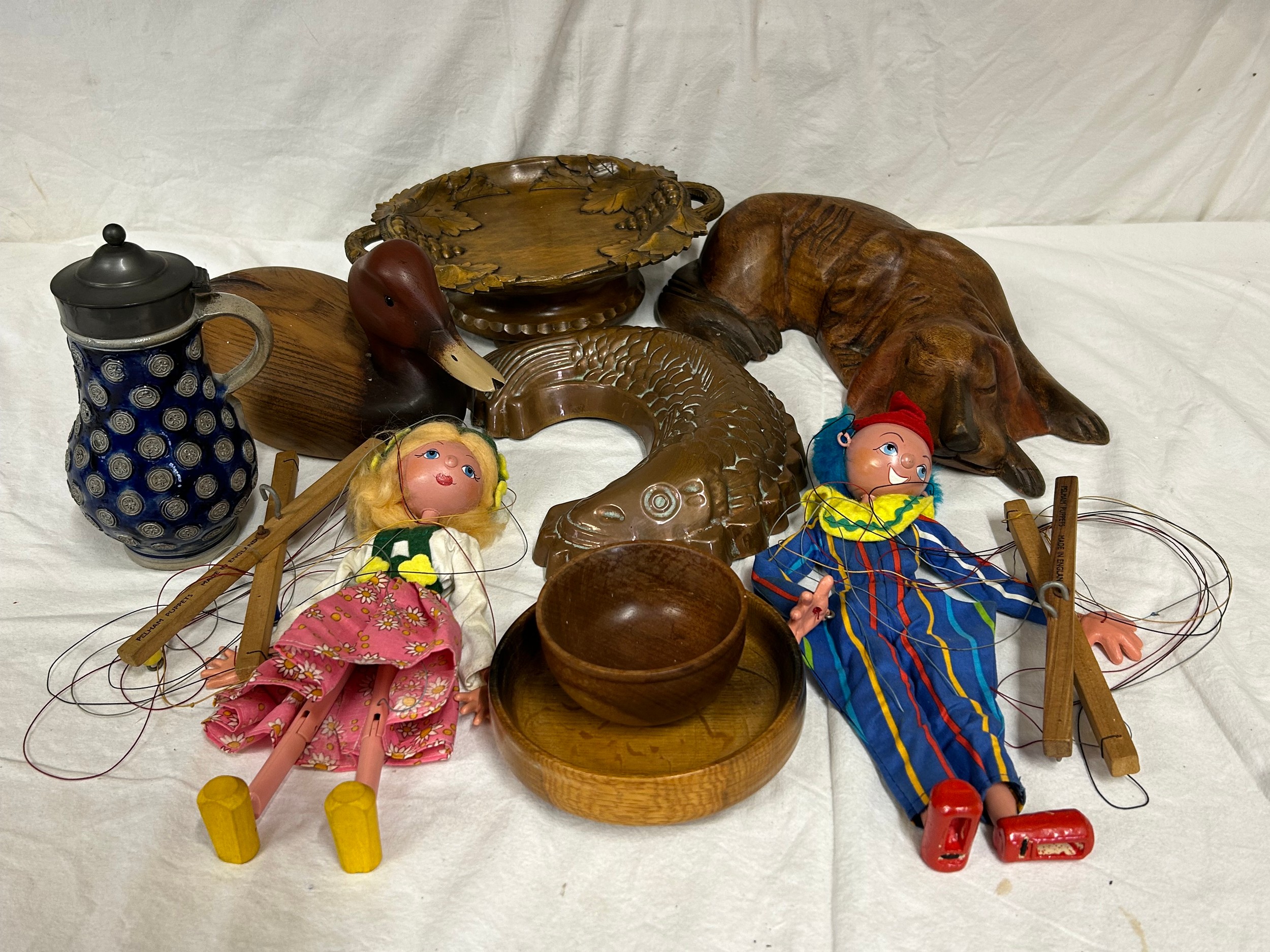 An assortment of items to include a wooden duck and sleeping dog, a Swiss wooden musical fruit bowl,