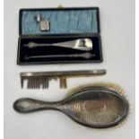 A boxed silver handled shoe horn and button hook, a silver backed hairbrush and comb together with a