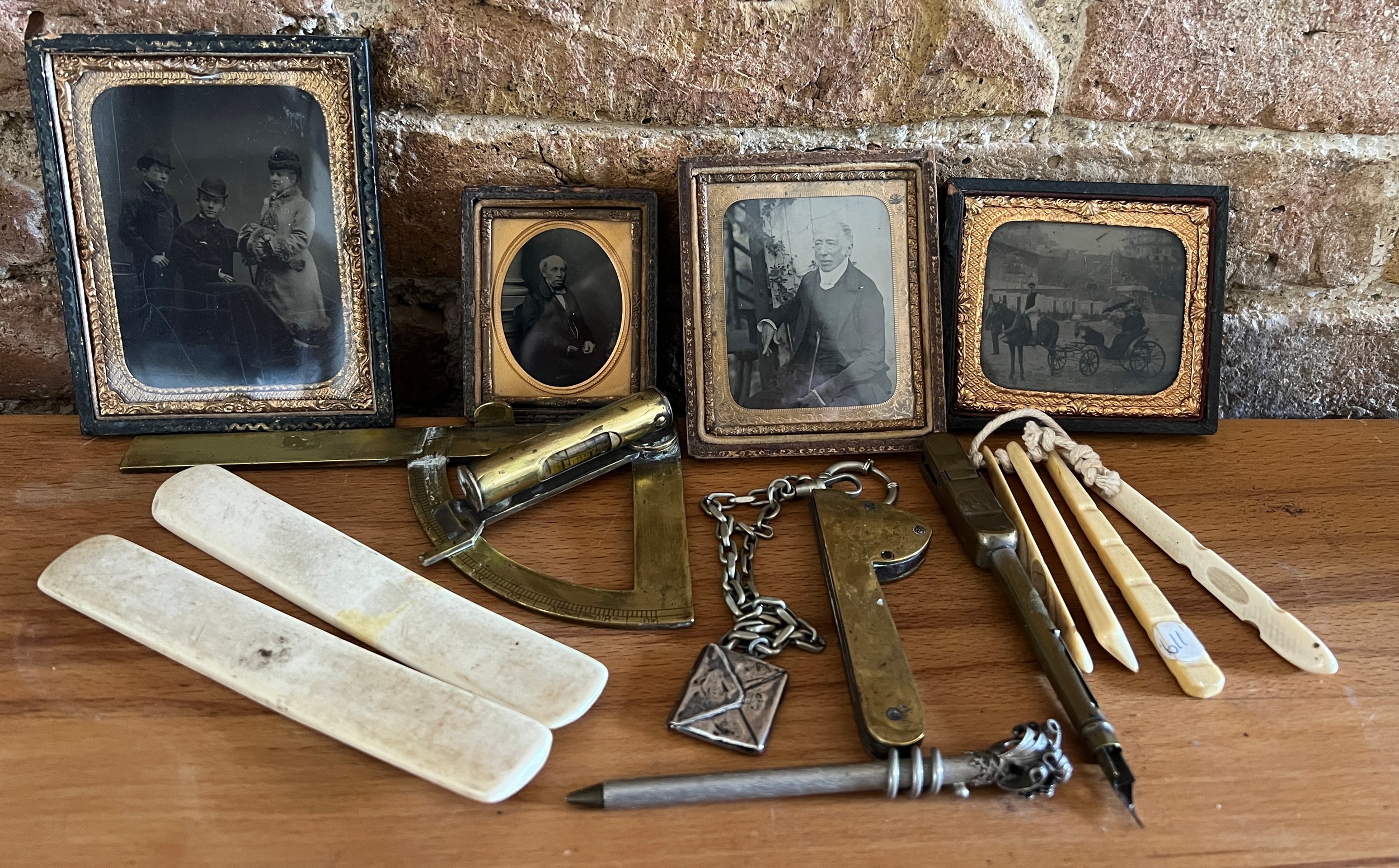 A miscellaneous lot to include daguerreotypes, a brass protractor/spirit level, a brass fleam, a