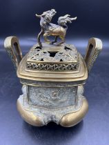 A Chinese brass incense burner with Dragon and Dog decoration. Mark to base. 23cm h.