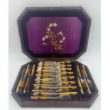 A 19thC set of twelve fish knives and forks in a silk lined fitted mahogany box. Floral embroidery