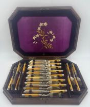 A 19thC set of twelve fish knives and forks in a silk lined fitted mahogany box. Floral embroidery