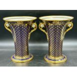 Two twin handled vases with gilt decoration on a blue ground. Marks to base - Sevres 1838, one with